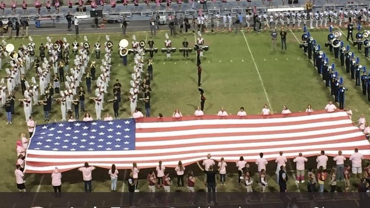 A large American flag was displayed on the field while the marching bands from both Clovis West High and Clovis North joined to play the National Anthem before a 2017 game.