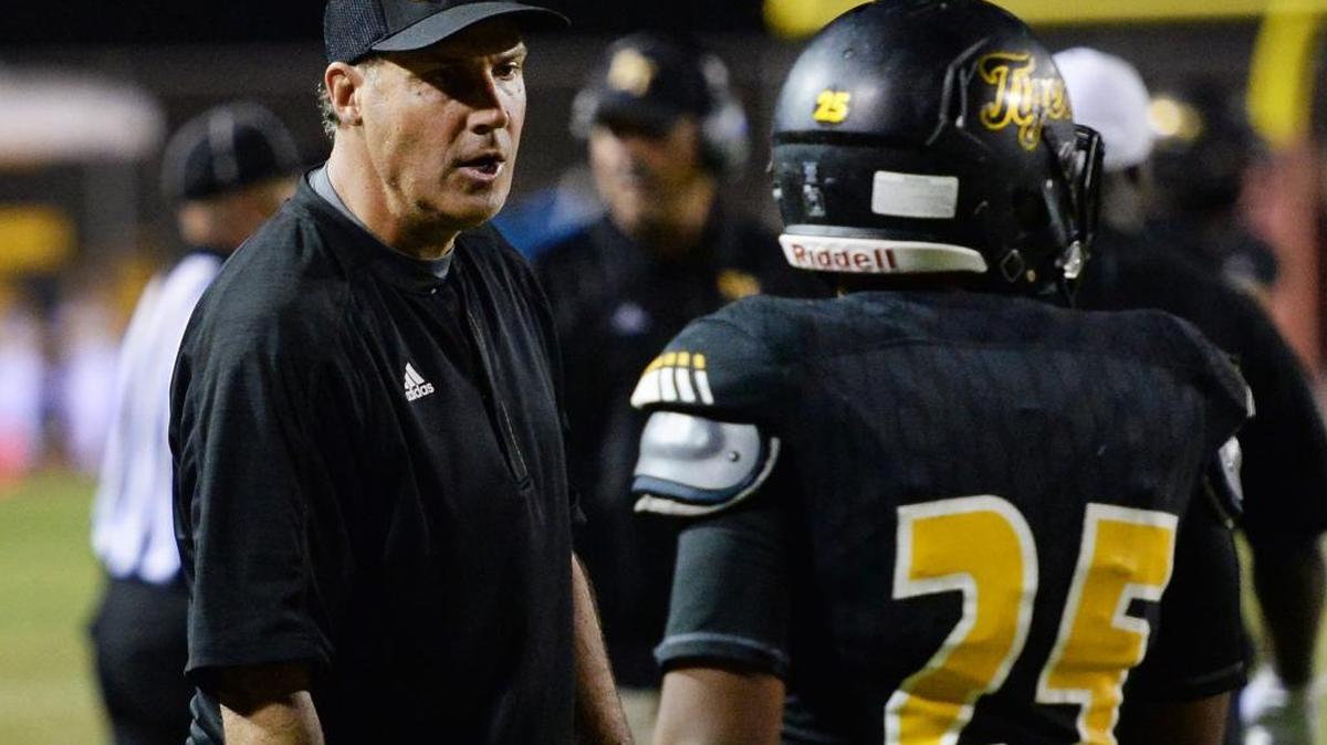 Edison High coach Matt Johnson checks in with running back Jaylan King during their game against Memorial on Thursday, Oct. 13, 2016, at Sunnyside. The Tigers won 35-25, their second straight victory after opening the season 0-5.