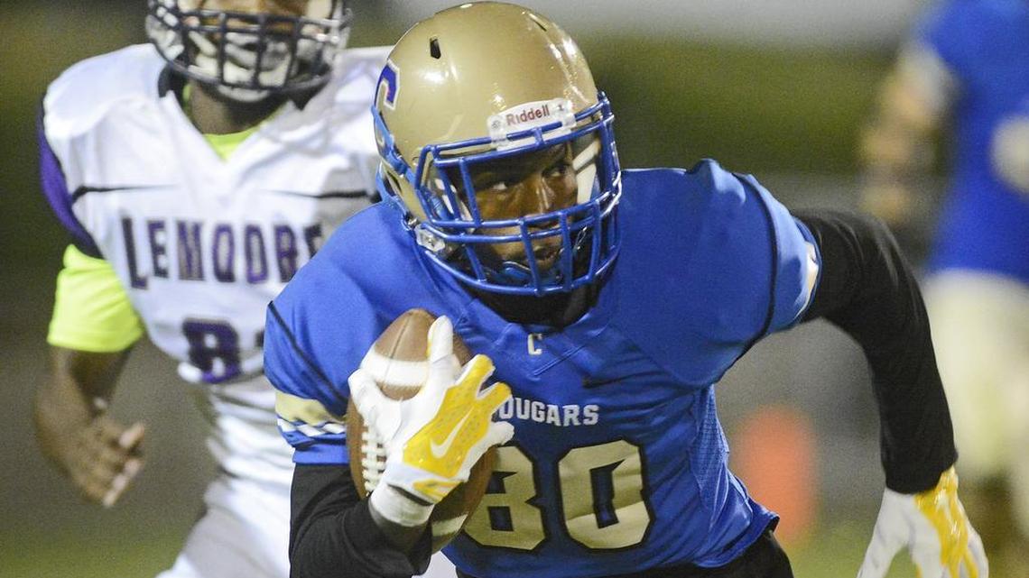 
Clovis High’s JJ Wills turns upfield against Lemoore in Friday’s game at Lamonica Stadium. Wills finished with 124 yards receiving in the Cougars’ 41-24 win.

