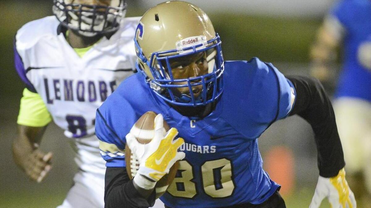 
Clovis High’s JJ Wills turns upfield against Lemoore in Friday’s game at Lamonica Stadium. Wills finished with 124 yards receiving in the Cougars’ 41-24 win.

