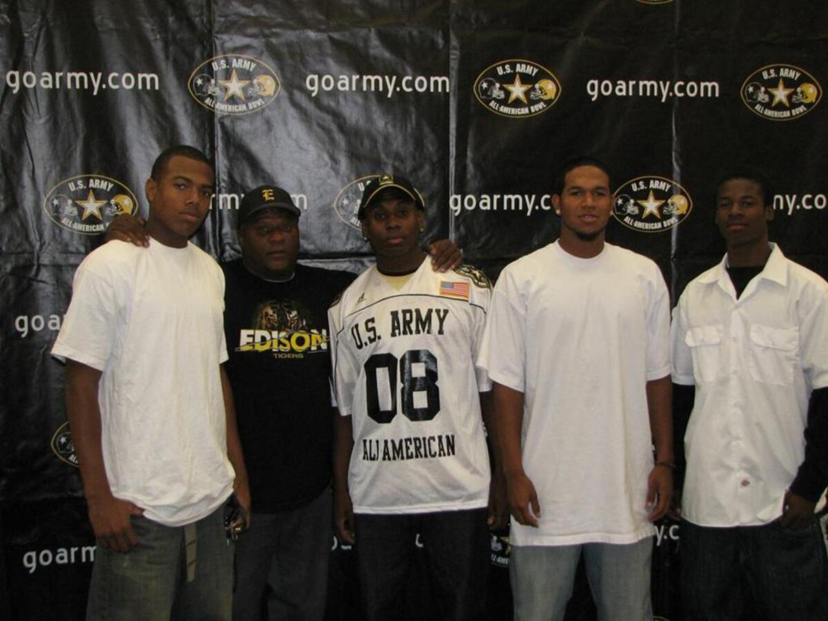 Tony Perry (second to the left) was instrumental in the development of many Edison High and Central football players over the years, helping send them earn scholarships to play college football. Some even went on to reach the NFL, such as T.J. McDonald (left) and Robert Golden (middle).