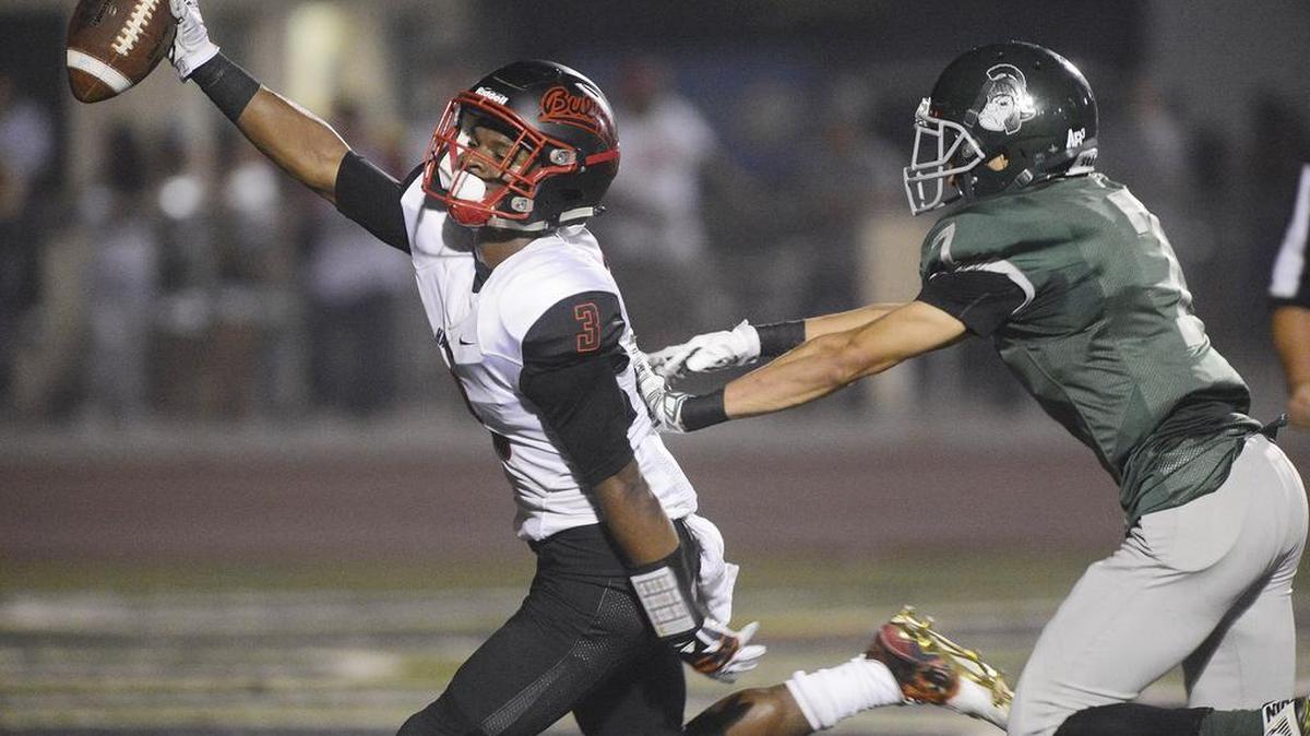 
Hanford’s Juwuane Hughes, left, celebrates after catching a touchdown catch while defended by Dinuba’s Daniel Guzman in the Bullpups’ 45-21 road win Friday. Hughes is starring again as a wide receiver/cornerback after leading Hanford to section titles in football (Division III) and basketball (D-II) as a junior.

