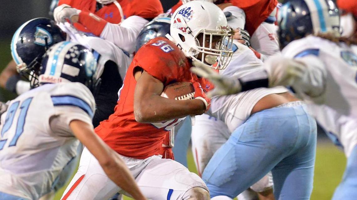 Buchanan’s Kendall Milton carries the ball past Bullard’s defense during their Central Section Division I playoff game on Nov. 10, 2016, in Clovis.