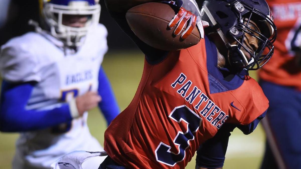San Joaquin Memorial’s Leonard Glass, right, scrambles for yardage against Bakersfield Christian in the Central Section D-III championship game Friday, Nov. 23, 2018 in Fresno.