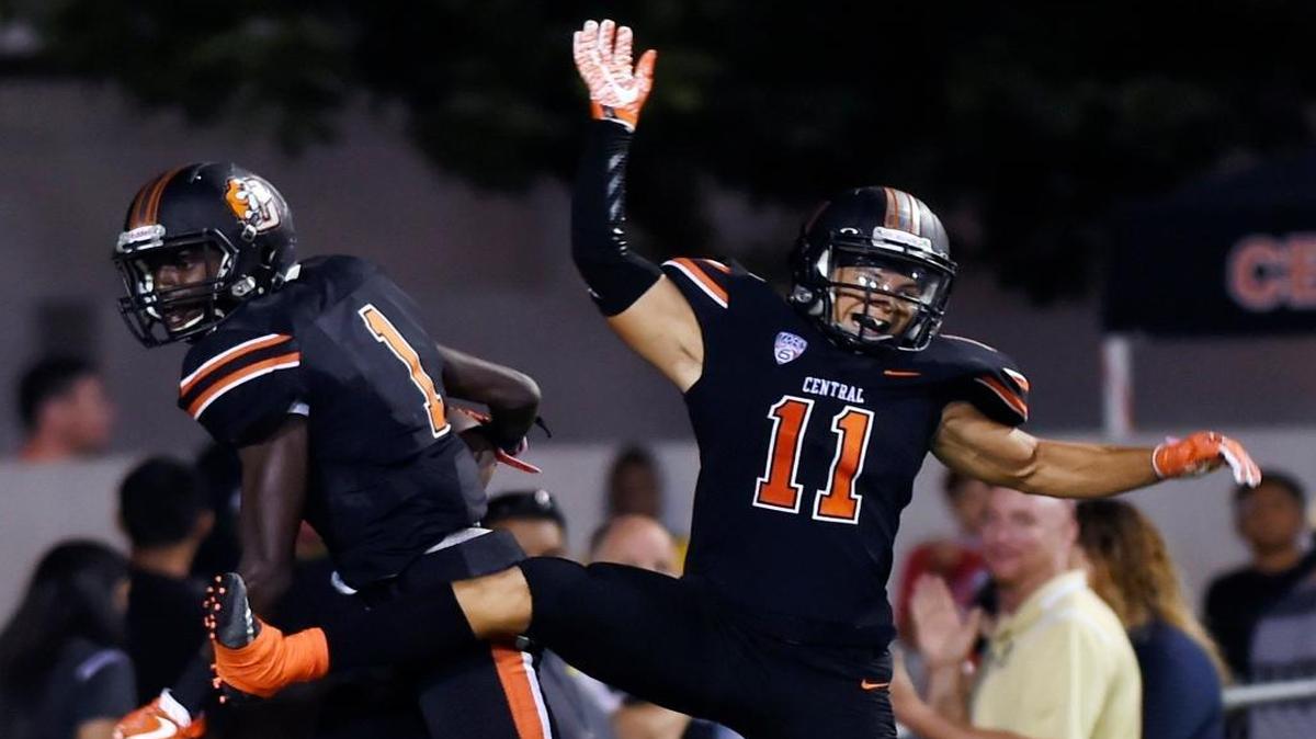 Central High’s Tyrell Grayson, left, and Jacob Torrez, right, celebrate Grayson’s touchdown against Liberty-Bakersfield Friday, Sept. 8, 2017 in Fresno, Calif. Central trounced Liberty 30-3.