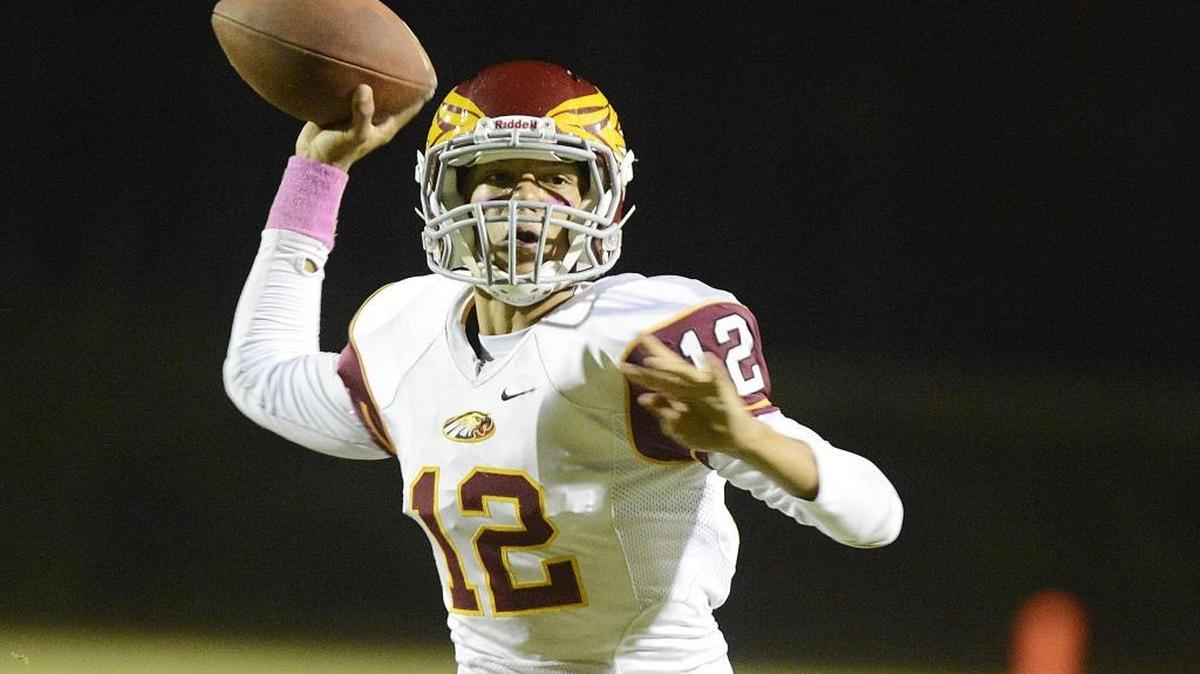 
Clovis West quarterback Adrian Martinez throws to the end zone against Edison in their game at McLane High stadium on Oct. 2, 2015.
