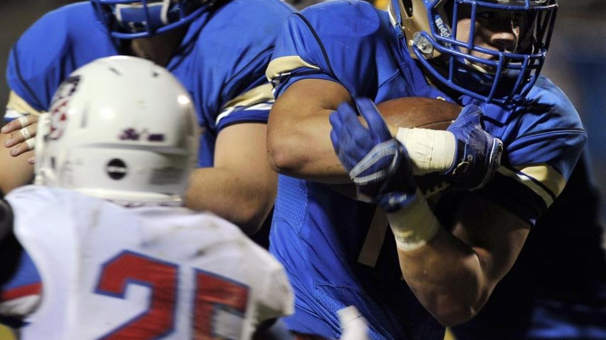 Clovis High’s Josh Hokit, right, carries the ball against Buchanan in the first half of the teams’ Tri-River Athletic Conference game Oct. 23, 2015. Hokit ran for two touchdowns as the Central Section fourth-ranked Cougars beat the No. 6 Bears 34-13.
