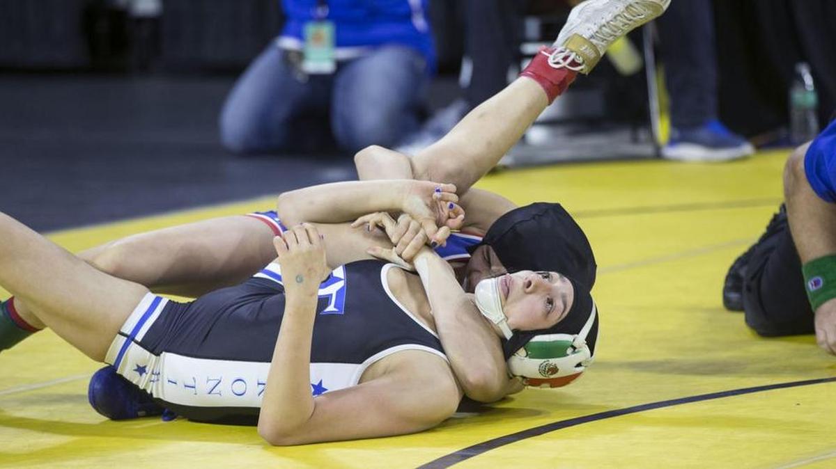 Freshman Cristelle Rodriguez of Buchanan, top, scores a 14-2 major decision over Jacqueline Hernandez of Frontier in the quarterfinals. Rodriguez went on to win the state title at 101 pounds.