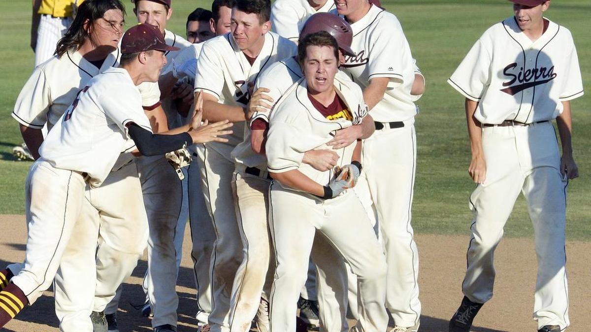 Sierra players celebrate with teammate Harry Blunt, center, who got the winning hit against Kern Valley in the bottom of the seventh inning for the CIF Division VI baseball title at Rawhide Stadium in Visalia, Tuesday, May 31, 2016.