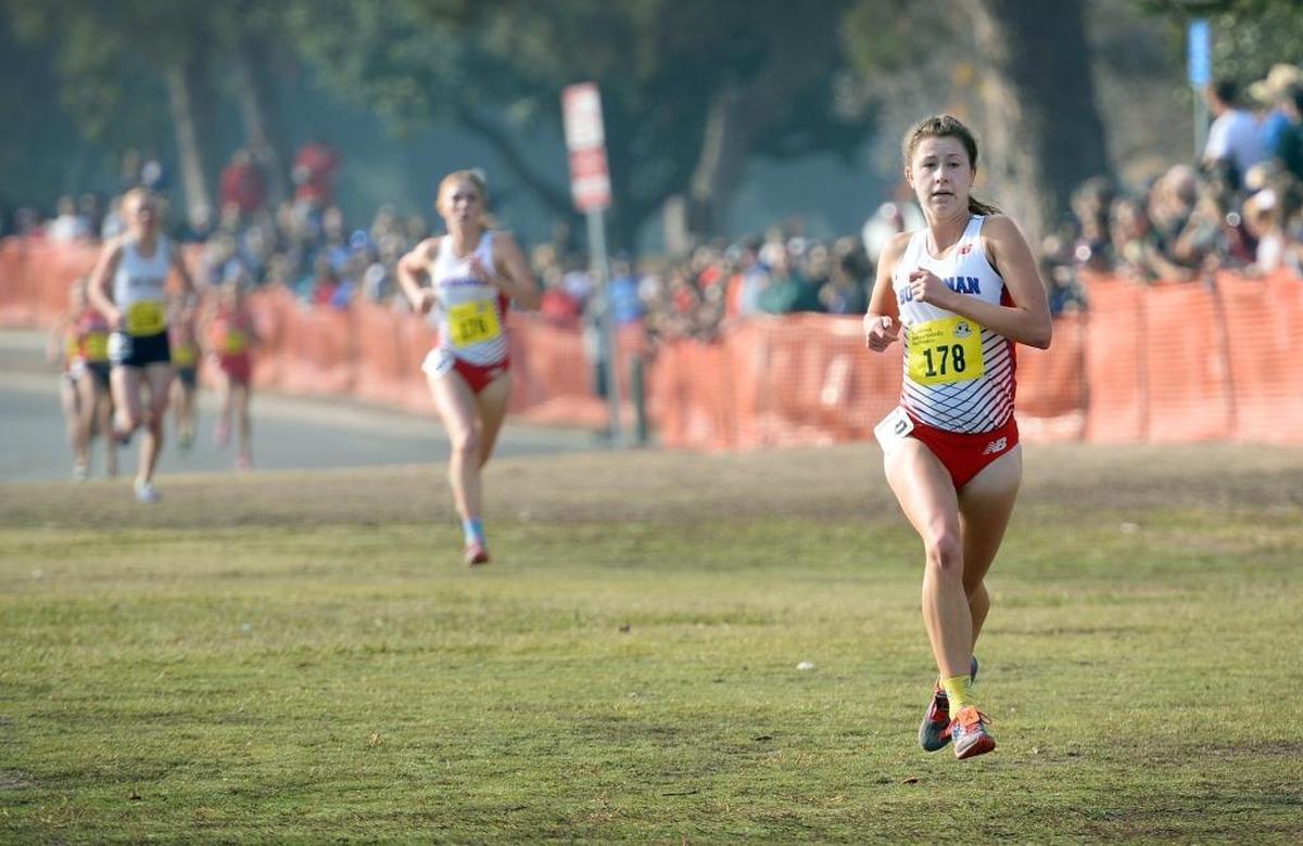 Buchanan’s Corie Smith, right, lengthens her lead down the stretch in the girls Division l race at the 2017 CIF State Cross Country Championships at Woodward Park in Fresno on Saturday, Nov. 25, 2017. Smith and teammate Meagen Lowe finished first and second consecutively but the team got edged out for first overall by Great Oak.