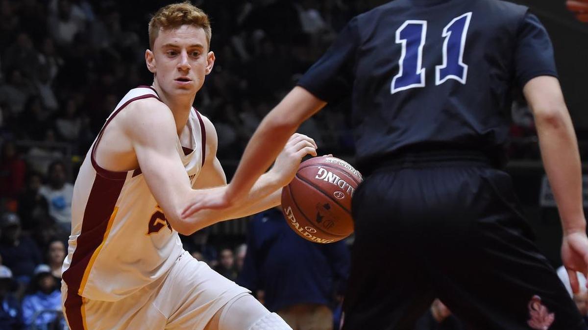 Clovis West’s Alex Villi, left, drives past Bulllard’s Nicholas Tom, right, in the Central Section boys Division I basketball championship Saturday night at Selland Arena. Villi scored 42 points in the Golden Eagles’ 89-81 double-overtime victory.