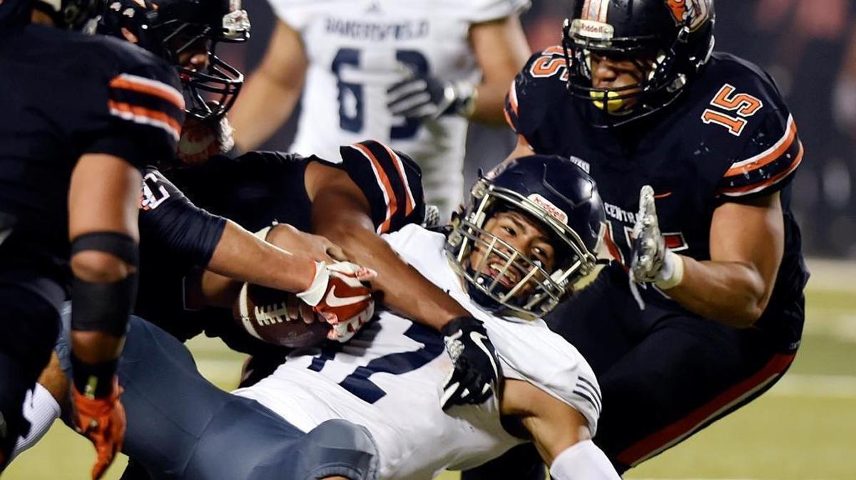Central High’s Dominic Mendez, Diotry Brewer and Marcus Washington, right, combine on a second-quarter sack of Bakersfield’s Caden Ochoa in a Central Section Division I semifinal Friday, Nov. 24, 2017. The top-seeded Grizzlies beat the No. 5 Drillers 35-27 and will host No. 3 Buchanan in next week’s championship.