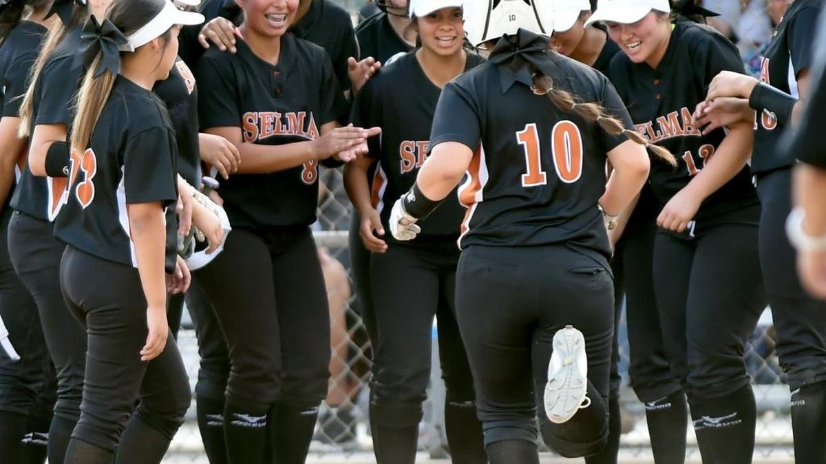 Selma’s Ally Trevino is greeted after hitting a home run in the third inning of a 10-2 victory over Dos Palos in a Central Section Division IV semifinal on Wednesday. The top-seeded Bears will face No. 2 Mission Oak for the championship at 11:30 a.m. Saturday at Fresno State’s Margie Wright Diamond.