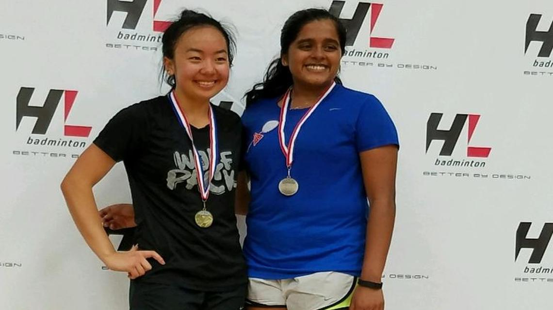 Central Section badminton individual champion Rose Vang, left, of Clovis East, stands alongside runner-up Sravya Gudipudi of Buchanan after Saturday’s finals.