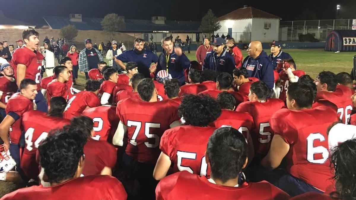 Strathmore High coach Jeromy Blackwell addresses his team after a 42-32 win against Rosamond on Friday, which gave the Spartans a second straight Central Section Division VI championship. Strathmore also is 13-0 for the second consecutive season.