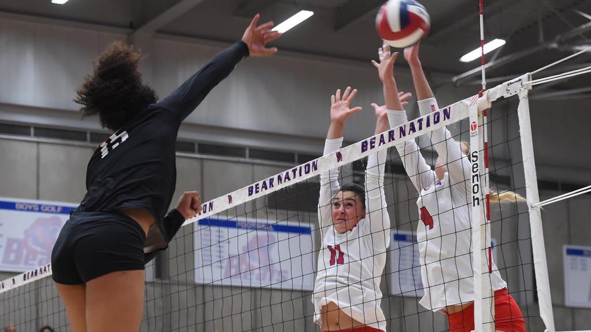 Central’s Amethyst Harper, left spikes the ball for a point in Game 3 against Buchanan’s Haley Barsotti, center, and Ashley Dittman, right, in the Northern California girls volleyball championship Tuesday, Nov. 13, 2018 in Clovis.