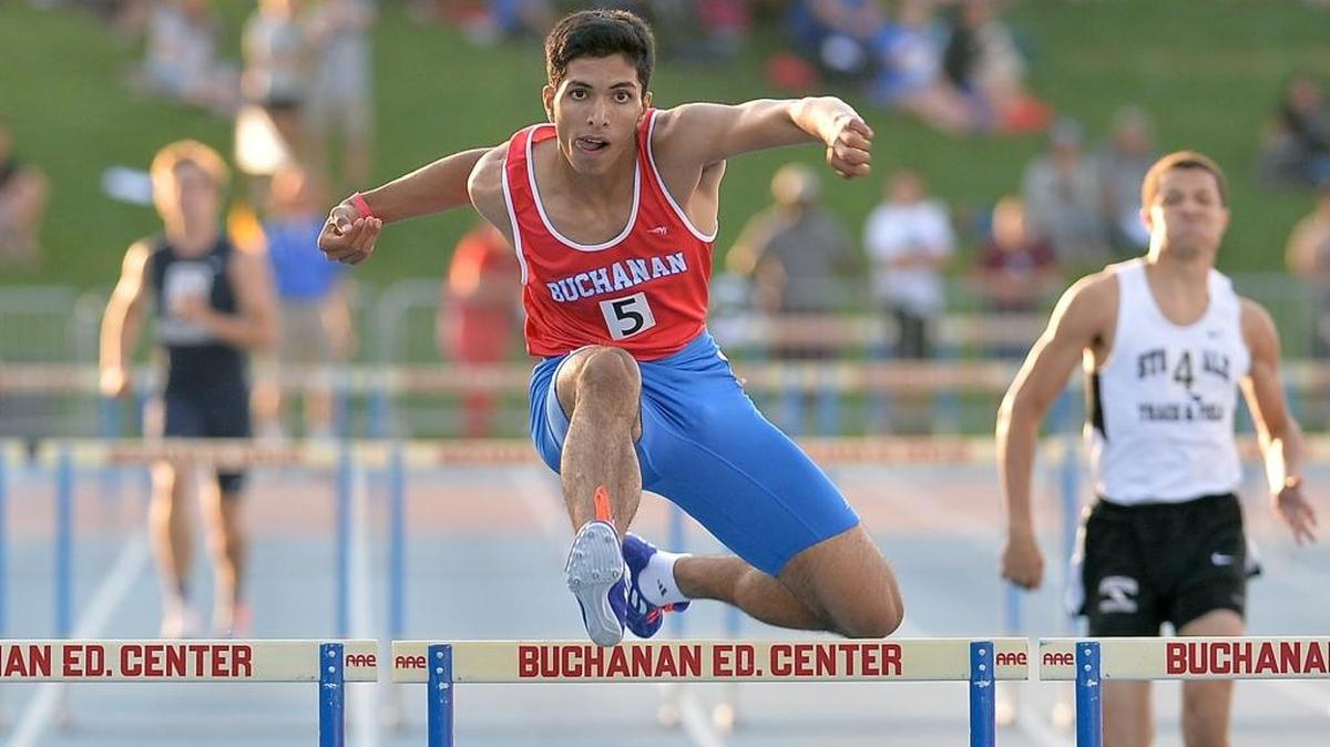 Buchanan High’s Paramveer Chohan clears the last hurdle at the boys 300 at the 2015 Central Section Masters Track and Field Championships at Veterans Memorial Stadium.