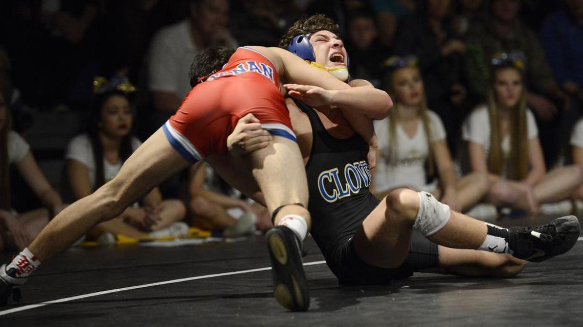 Clovis’ Dylan Martinez, right, wrestles against Buchanan’s DJ Lloren in the 140-pound match of their TRAC wrestling match at Clovis, Thursday, Jan. 28, 2016.
