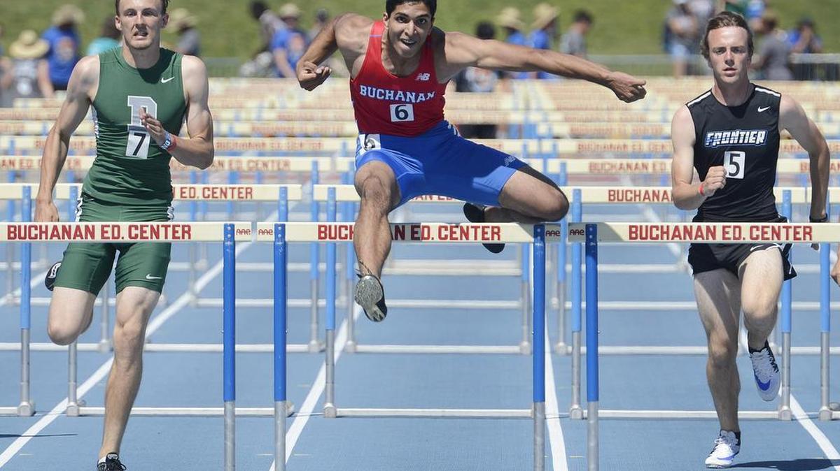 Buchanan's Paramveer Chohan, center, jumps the final hurdle in the boys 110 hurled before winning the race at the West Coast Track and Field Relays at Buchanan High Saturday, April 2, 2016.
