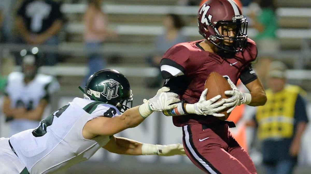 
El Diamante’s Nolan Montgomery, left, tries to tackle Mt. Whitney’s Jose Cisneros in the first quarter on Friday, September 25, 2015, at Mineral King Bowl in Visalia, California.
