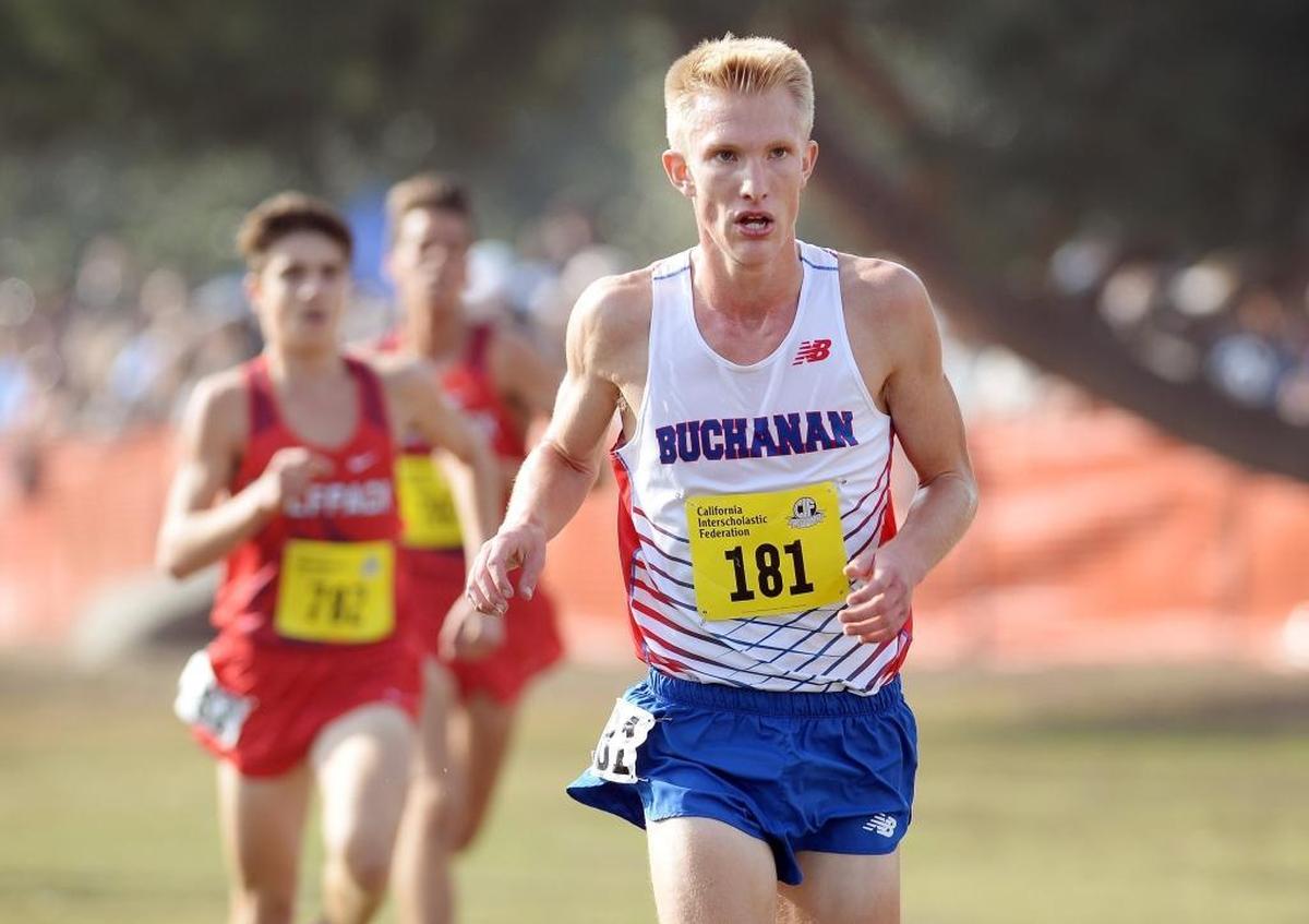 Buchanan’s Hayden Hansen, right tries to keep the pace in the boys Division l race at the 2017 CIF State Cross Country Championships at Woodward Park in Fresno on Saturday, Nov. 25, 2017.