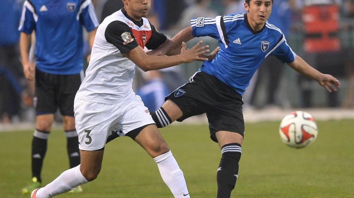 Fresno Fuego player Eddie Gonzalez, left, fights San Jose Earthquakes midfielder Amir Bashti for the ball during their Feb. 15, 2014, exhibition at Chukchansi Park.