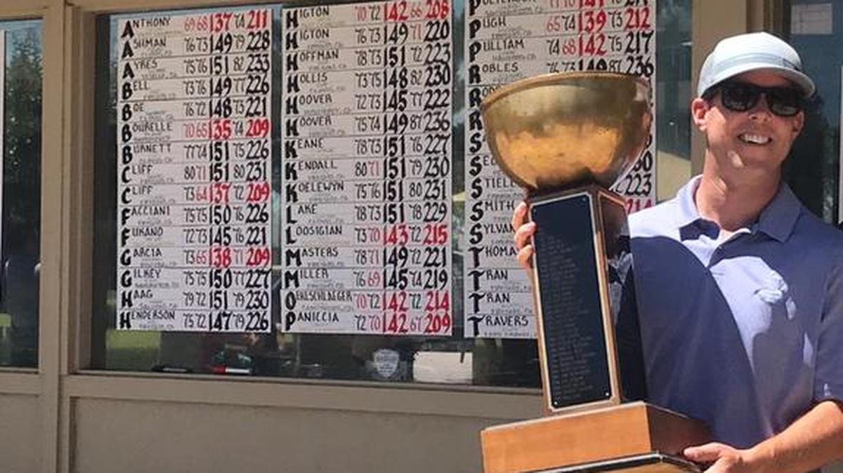 Jason Higton shows off the 91st annual Fresno City Amateur Golf Championship trophy at Riverside Golf Course.
