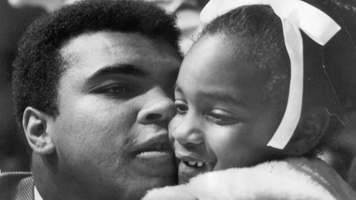 In his apparent only Fresno visit, Muhammad Ali gives 7-year-old Elicia Pace a hug. The occasion was a May 20, 1971 benefit boxing show at Selland Arena; among the planned beneficiaries was the family of Eddie Pace, a boxer from Los Angeles who had died a few months earlier. Only 257 fans showed up, so the promoter and the beneficiaries lost out. Ali didn’t let the Paces go home emptyhanded – he reportedly gave Elicia $500 and told her, “This is for you. Give it to your mommy and buy something nice.”
