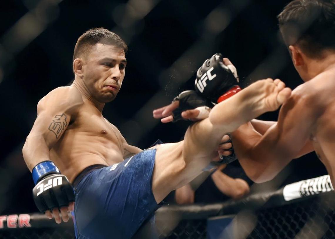 Lemoore’s Alex Perez, left, battles Carls John De Tomas in a bantamweight bout at UFC Fight Night 123 on Saturday, Dec. 9, 2017, at Save Mart Center. Perez won by submission in the second round of his UFC debut.