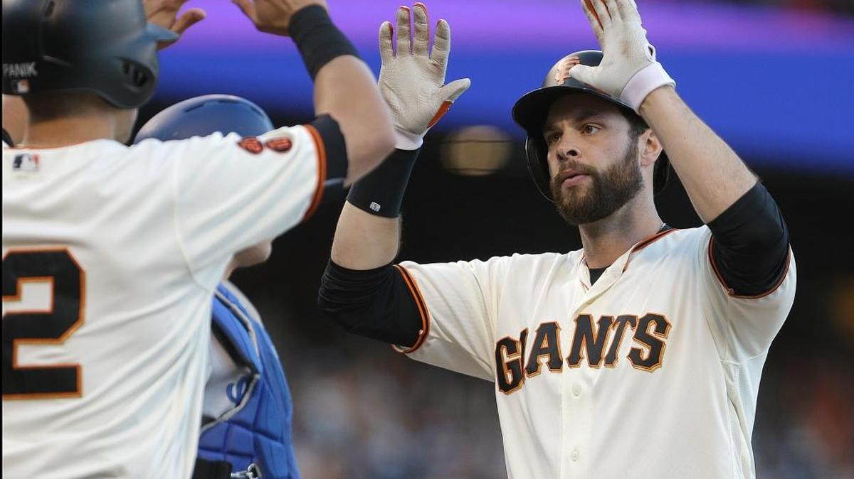 Giants first baseman Brandon Belt, right, celebrates with Joe Panik (12) after hitting a two-run home run off Los Angeles Dodgers pitcher Julio Urias in the sixth inning of a baseball game, Sunday, June 12, 2016, in San Francisco. The Giants won 2-1 and have beaten the Dodgers six times in 10 games this season.