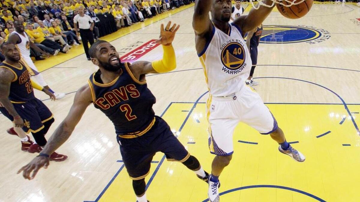 Kyrie Irving of the Cavaliers, left, can do nothing to stop a dunk by Golden State’s Harrison Barnes.