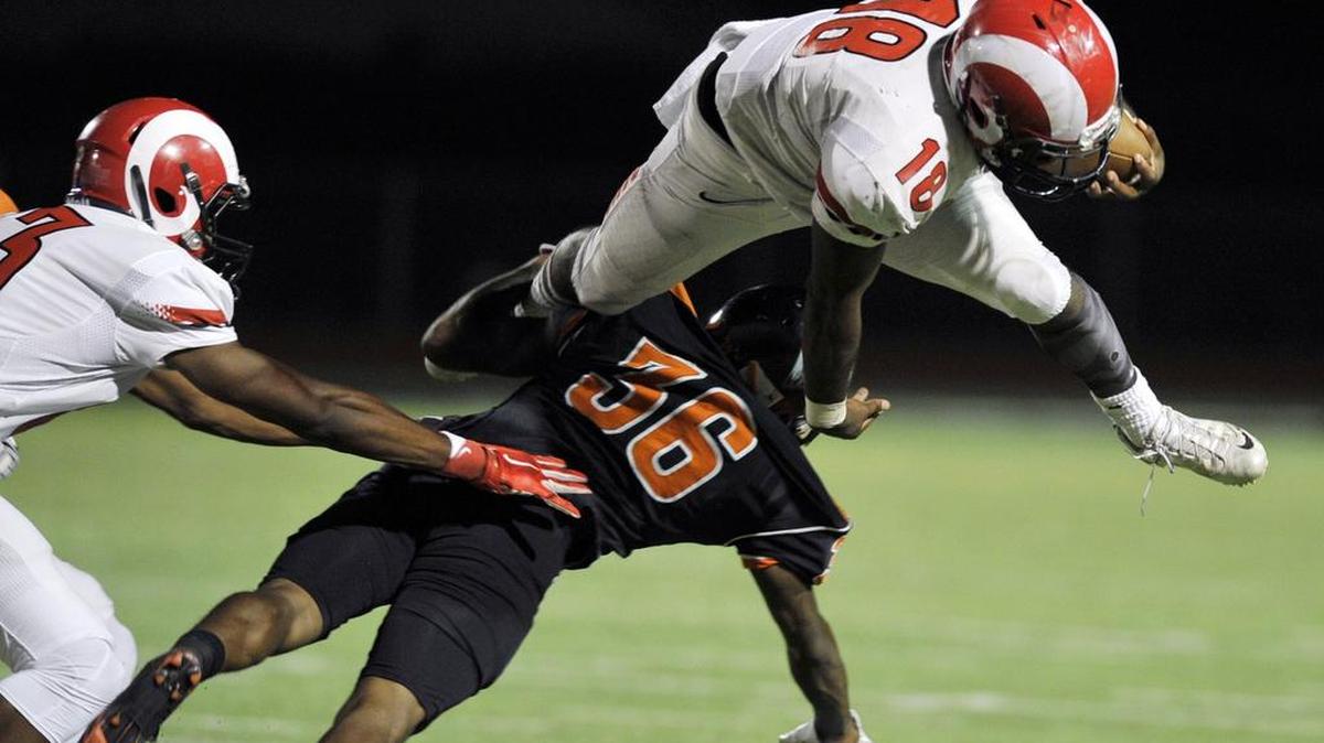 
Fresno City College’s Nate Jones leaps over Reedley College’s Anthony Nash, bottom, during the third quarter Saturday, Oct. 3, 2015 in Reedley, Calif. Fresno City won the rivalry game known as The Battle for the Pump for a seventh straight year.
