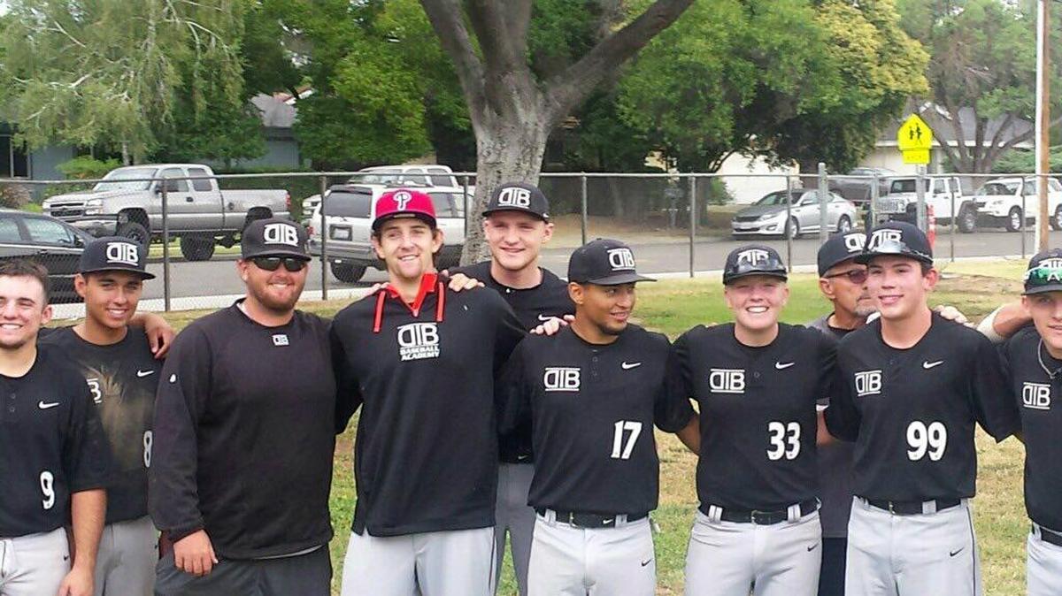 Central High’s Justin Miller, center, wearing a Phillies hat, takes a group photo with his DIB Baseball Academy travel club teammates after learning he had been taken by Philadelphia on Saturday in the Major League Baseball Draft. Miller, a 6-4, 183-pound right-hander, was selected by the Phillies as the first pick of the 12th round.
