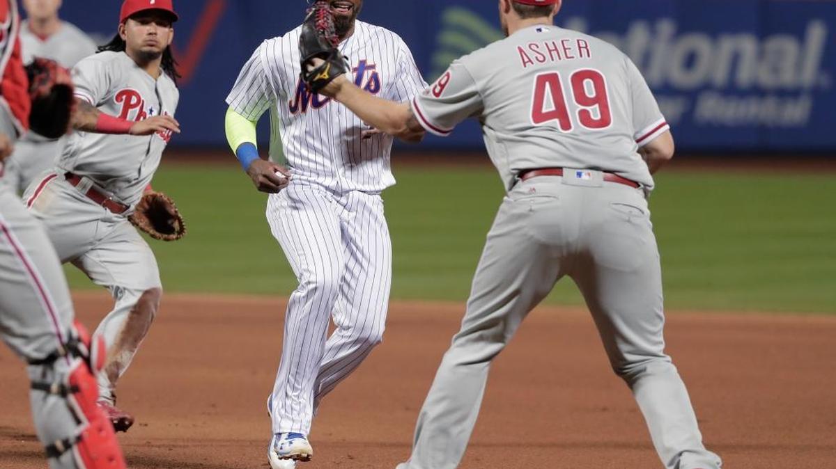 Philadelphia Phillies pitcher Alec Asher tags out Jose Reyes of the New York Mets on Saturday, Sept. 24, 2016, in New York. The Phillies held off the Mets 10-8.