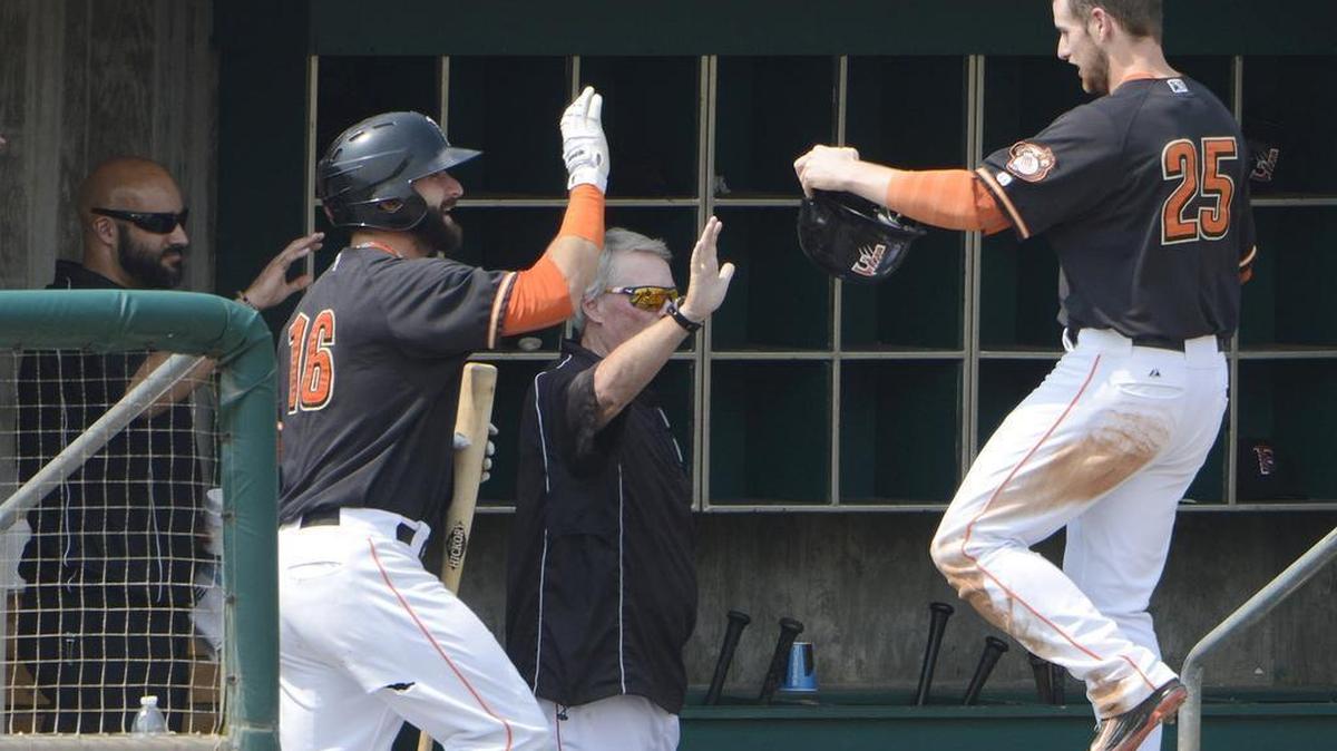 
Fresno's Alex Presley, right, is congratulated by teammates after scoring the first run of their game against Salt Lake at Chukchansi Park Monday, Sept. 7, 2015.
