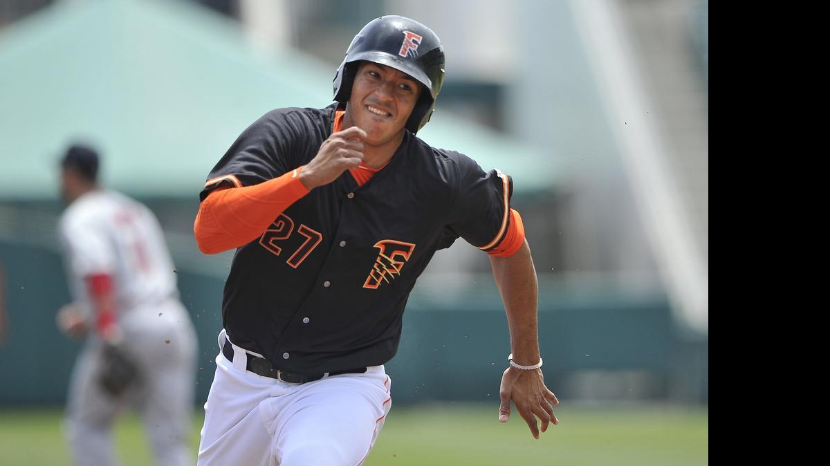 
Fresno Grizzlies runner Carlos Correa turns on the speed as he gets set to round third en route to scoring early in Thursday’s game against the Memphis Redbirds. The Grizzlies eventually won 5-4 on Joe Sclafani’s walk-off single in the 11th.
