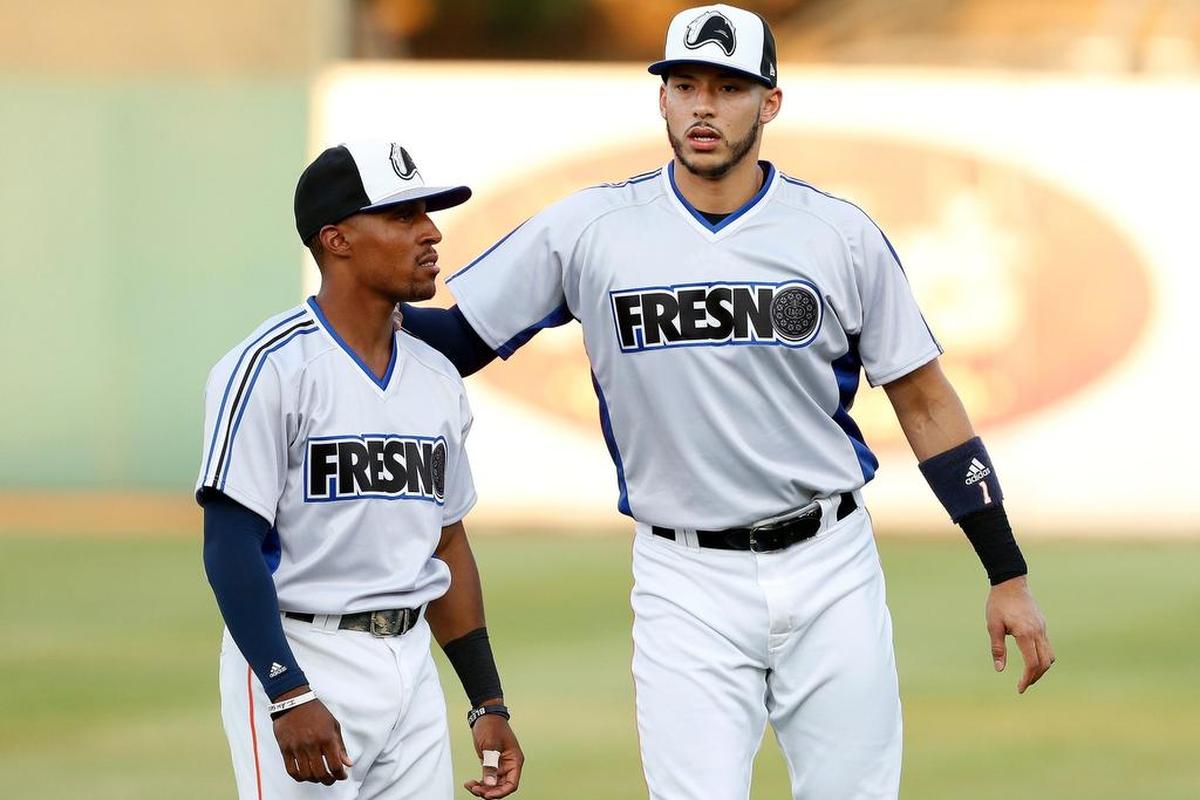 Houston Astros star Carlos Correa (right) talks with Fresno Grizzlies outfielder Tony Kemp before Thursday’s game at Chukchansi Park. Correa was playing in Triple-A again while beginning a minor league rehab stint. The Grizzlies were holding Oreo-theme night Thursday at Chukchansi Park, which included customized Oreo-theme uniforms.