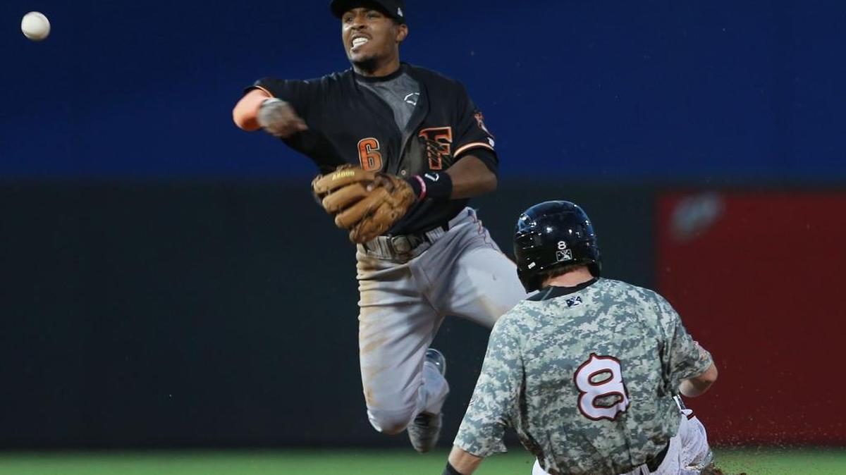 
Fresno second baseman Tony Kemp throws over sliding El Paso baserunner Casey McElroy to complete a 6-4-3 double play in the first inning.
