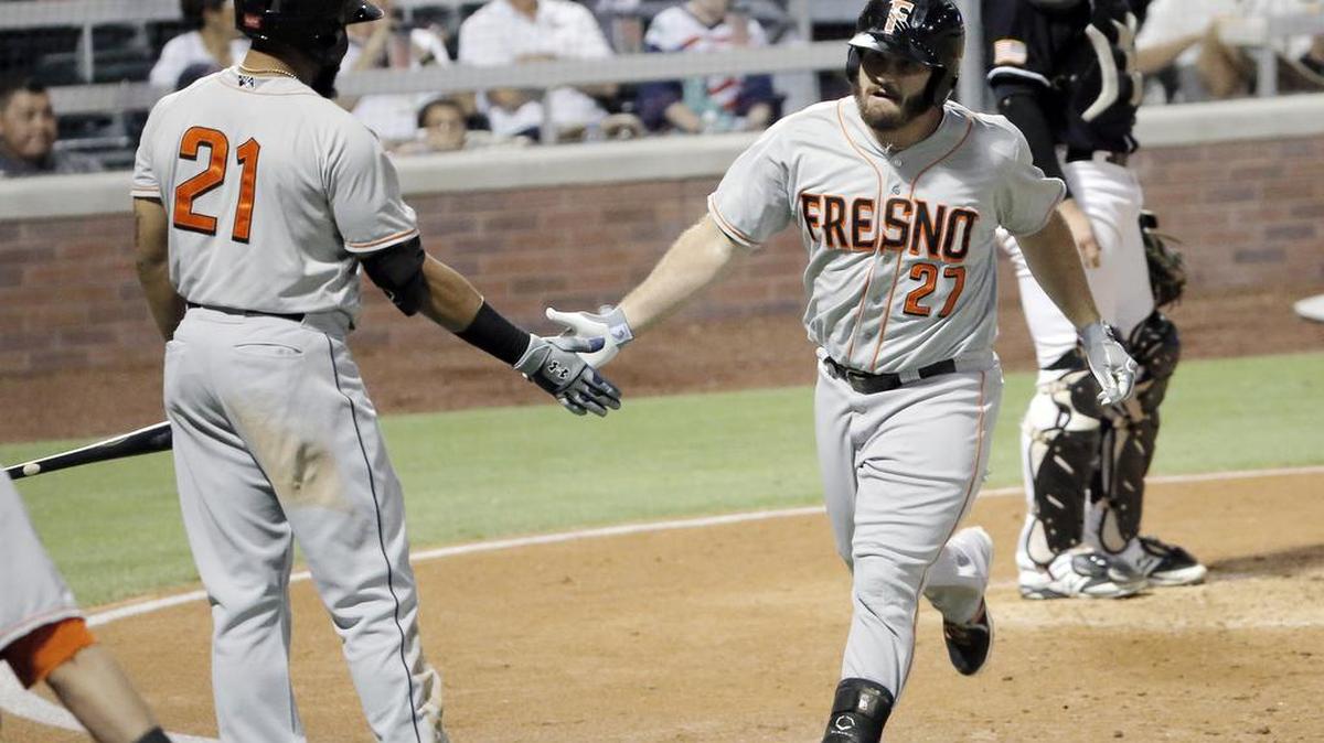 
Fresno’s Tyler White, right, celebrates his solo home run with teammate Jon Singleton Saturday against the Chihuahuas.
