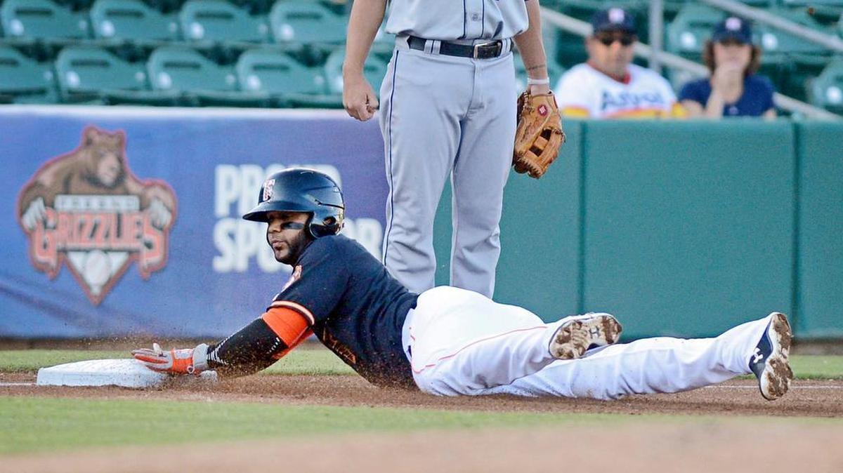 
Speed on the bases isn’t only about steals, as Fresno Grizzlies infielder Jonathan Villar shows while diving in safely after advancing from first to third on Alex Presley’s single in an April game at Chukchansi Park.
