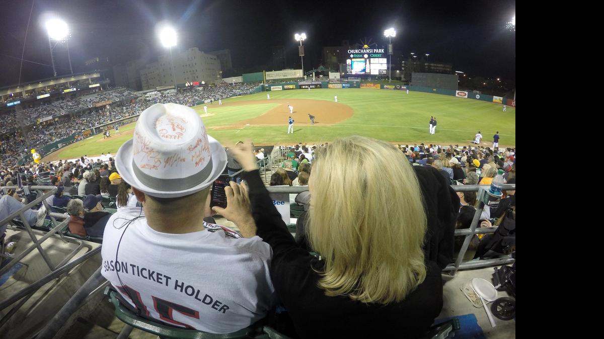 
Season ticket holder Tim Dunbar, left, and Connie Stewart enjoy the 2015 Triple A-opener and the Fresno franchise’s first game as a Houston Astros affiliate as the Grizzlies host the Las Vegas 51s at Chukchansi Park on April 9, 2015.
