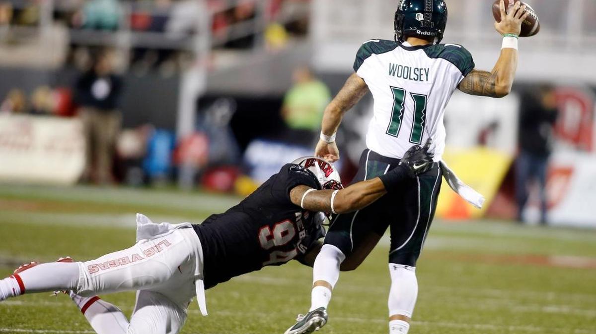 UNLV defensive lineman Jeremiah Valoaga sacks Hawaii quarterback Ikaika Woolsey during the second half on Nov. 7. UNLV defeated Hawaii 41-21. Woolsey will get the start against Fresno State on Saturday.