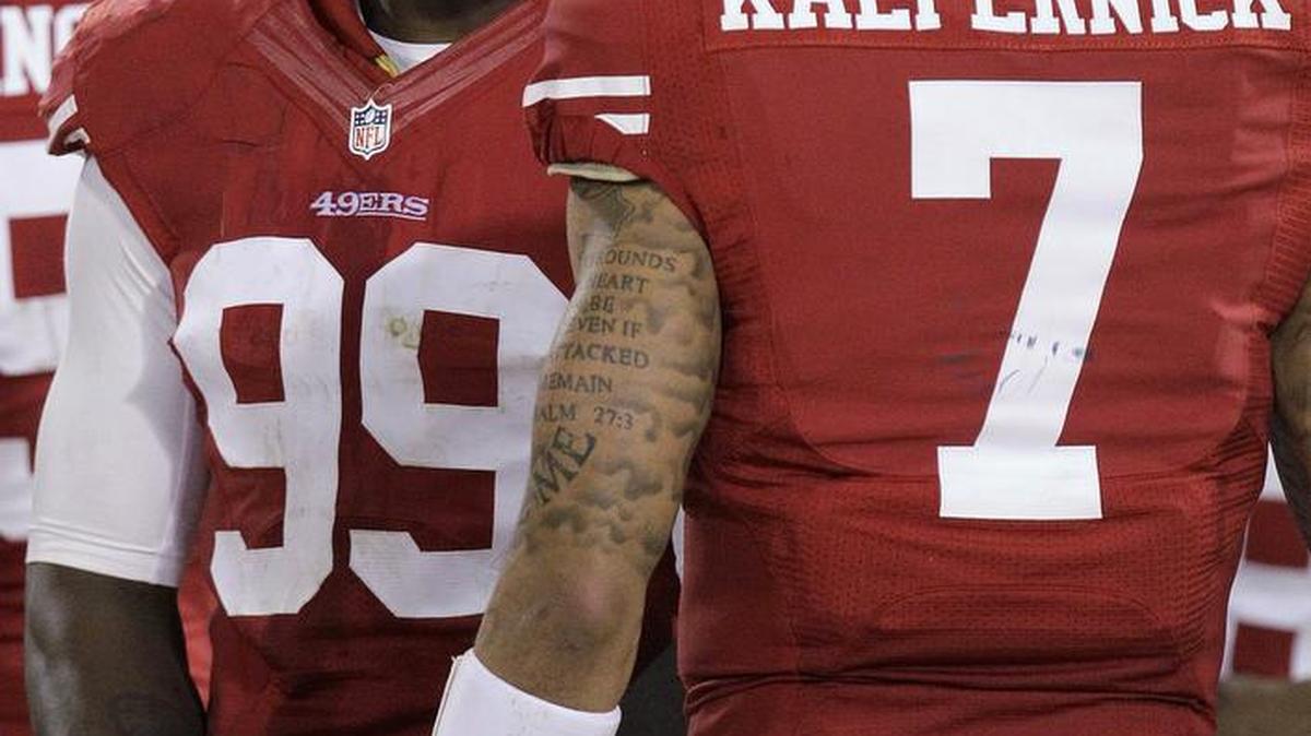 
San Francisco 49ers linebacker Aldon Smith (99) smiles as he talks with quarterback Colin Kaepernick (7) during the fourth quarter of an NFL football game against the Chicago Bears in San Francisco, Monday, Nov. 19, 2012. The 49ers won 32-7.
