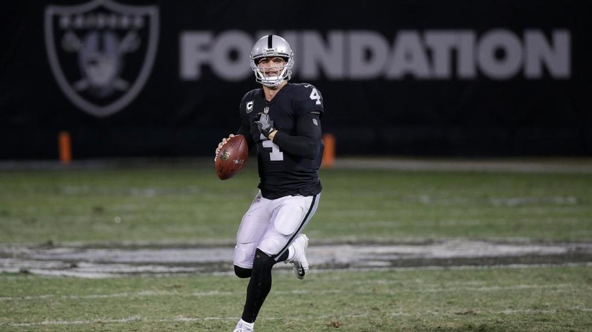 Oakland Raiders quarterback Derek Carr rolls out to pass against the Dallas Cowboys on Sunday night.