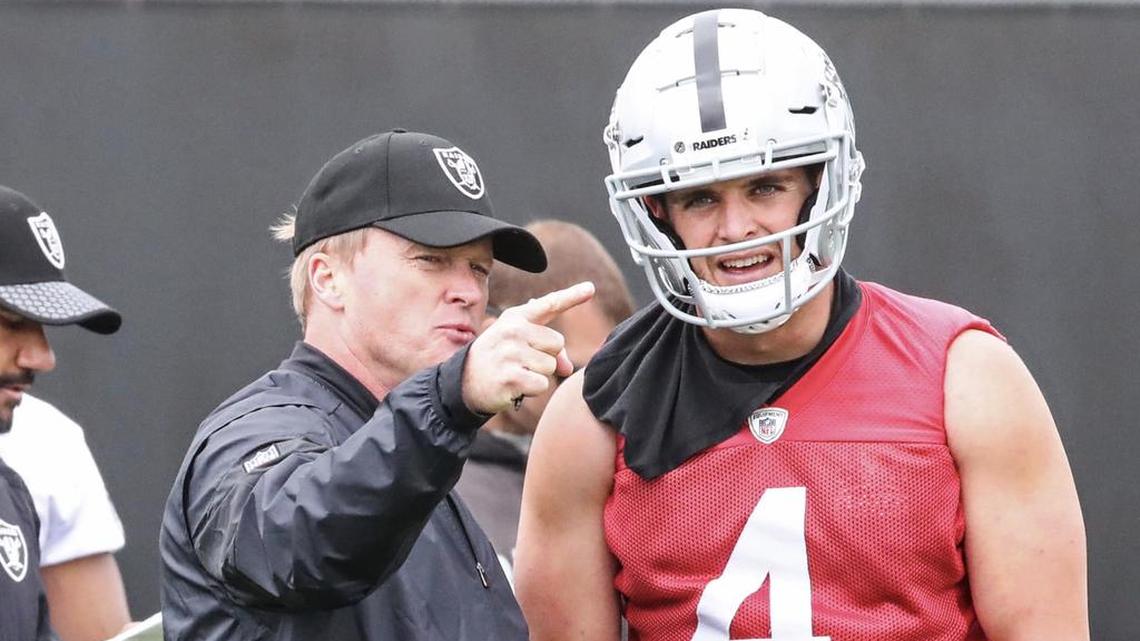 Oakland Raiders head coach Jon Gruden instructs quarterback Derek Carr at organized team activities this week in Alameda.