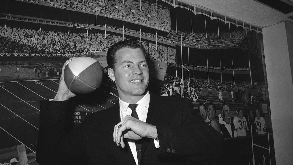 
This 1962 file photo shows New York Giants halfback Frank Gifford posing in front of photo mural of the Polo Grounds at the offices of the Giants in New York’s Coliseum. Gifford died suddenly at his Connecticut home of natural causes Sunday.
