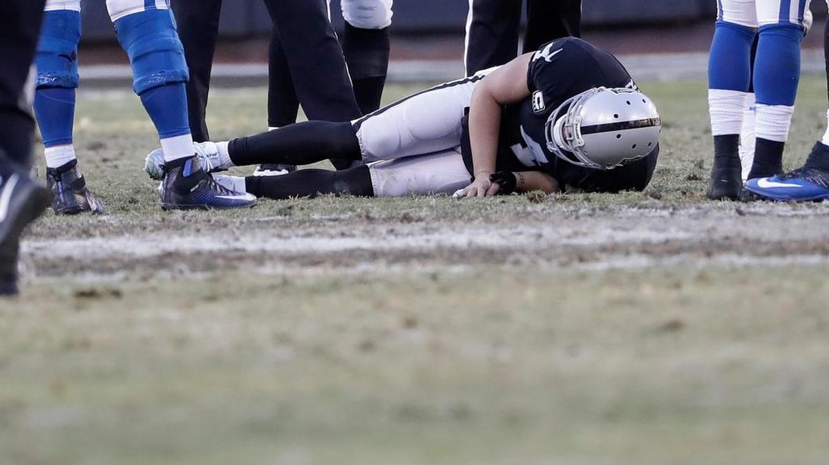 Raiders quarterback Derek Carr lays on the field after breaking his right fibula in Oakland on Saturday, Dec. 24, 2016.