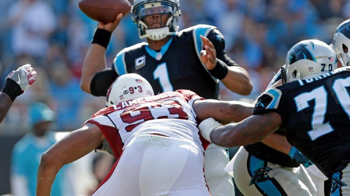 The Arizona Cardinals’ Calais Campbell (93) drives toward Carolina quarterback Cam Newton (1) as he looks to pass in the second half of an NFL football game in Charlotte, N.C., Sunday, Oct. 30, 2016. Campbell hit Newton after the throw, which Newton felt was an illegal hit that wasn’t called.