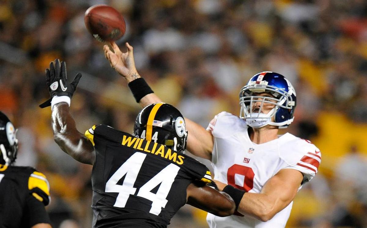 New York Giants quarterback David Carr (8) gets a pass off under pressure in a 2013 preseason game against the Pittsburgh Steelers.
