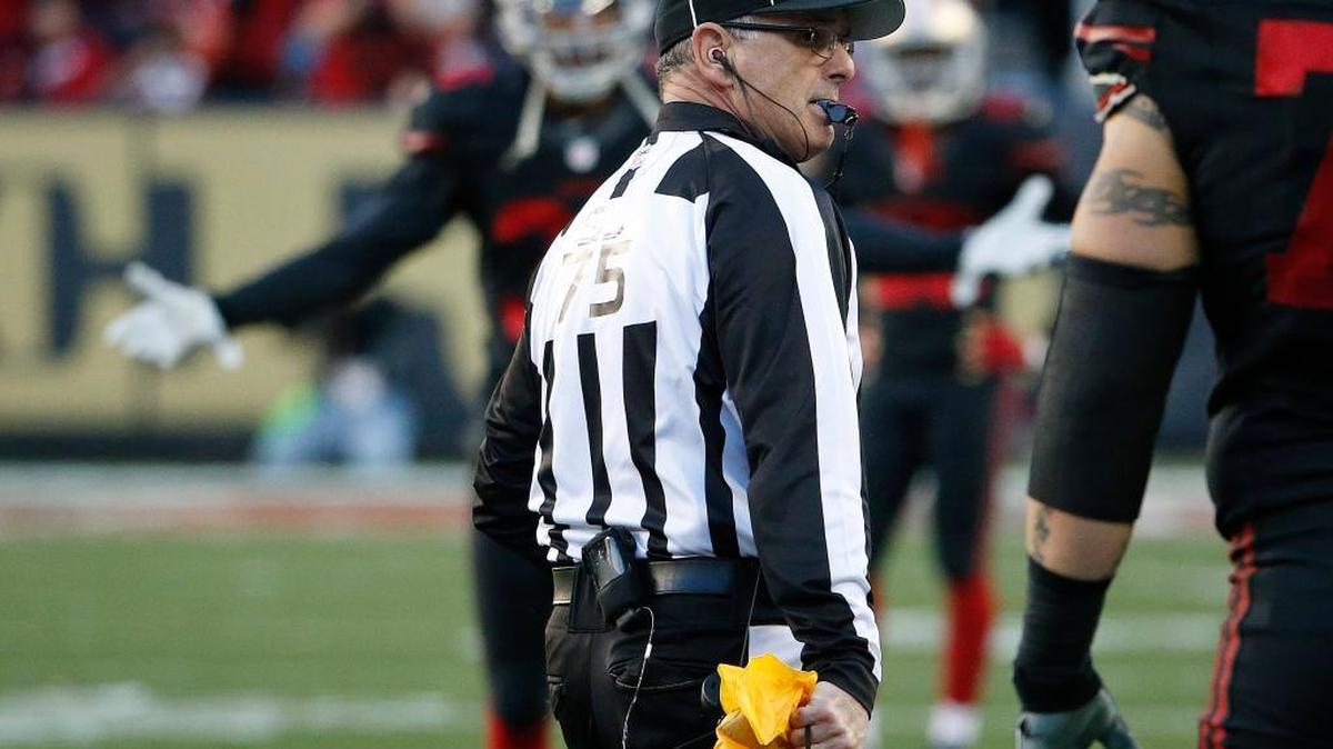 NFL side judge Rob Vernatchi (75) holds a penalty flag during the second half of an NFL football game between the San Francisco 49ers and the Arizona Cardinals in Santa Clara on Sunday, Nov. 29, 2015.